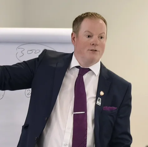 Aleem Cummins explaining an idea beside a flipchart
